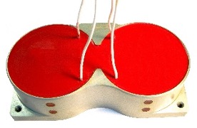 Two red-potted wound coils joined in a dumbbell shape on a machined metal mounting plate